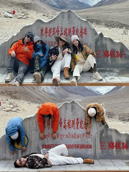 A group of people sitting on a monument with inscriptions and a number 8848.86. 1