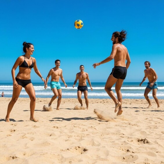People playing soccer on a beach. 3
