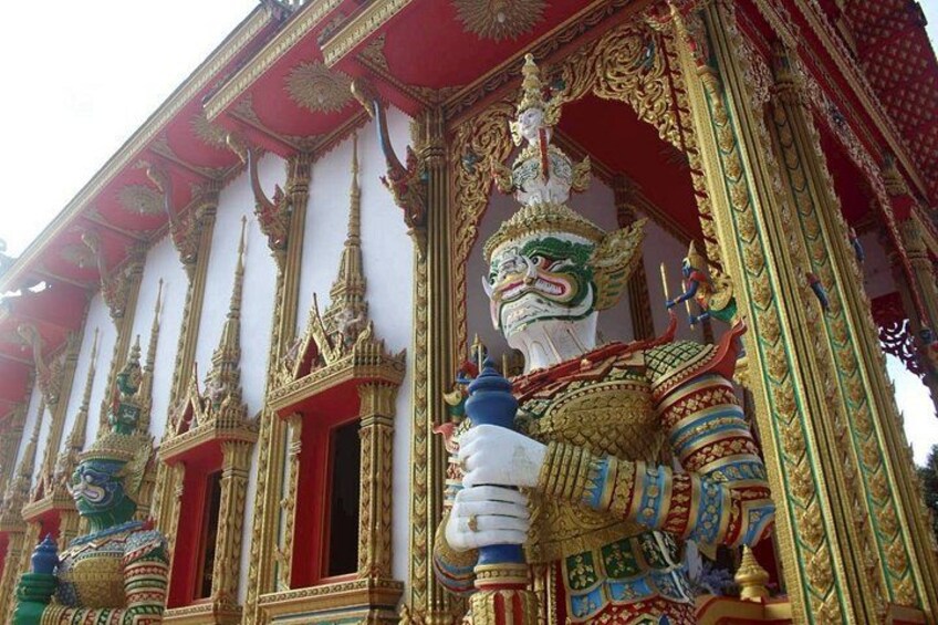 A temple with ornate golden and red decorations, including a large statue of a deity. 2