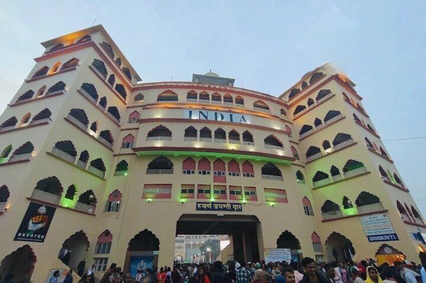 A multi-story building with arched windows and a sign that reads 'INDIA'. 5