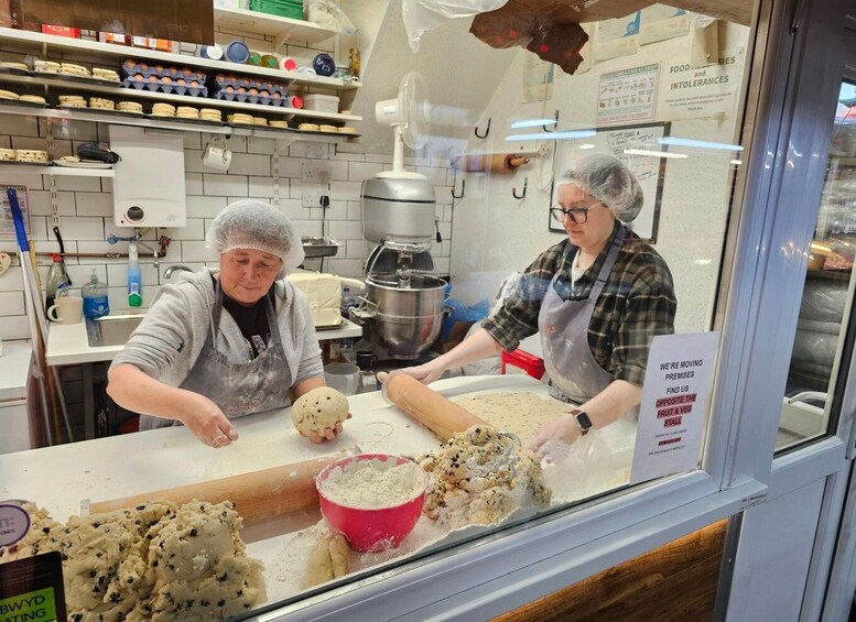 Two people working with dough in a bakery. 5