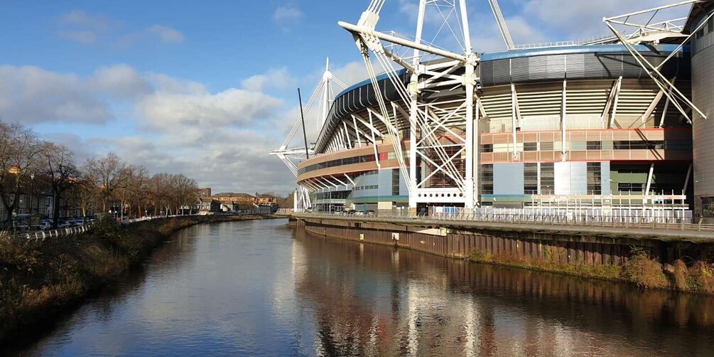 A modern stadium with a river in the foreground. 1