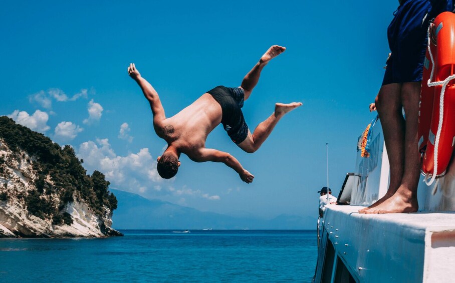 A person diving into the sea from a boat. 2