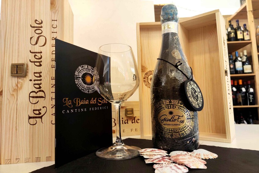 A bottle of wine, a wine glass, and a box with text. 5