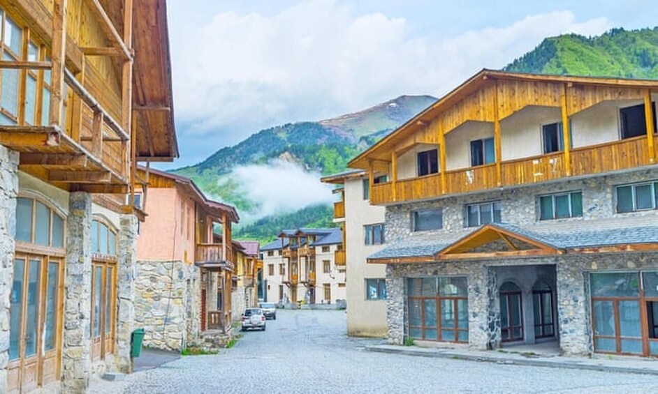 A mountain village with wooden buildings and stone facades. 2