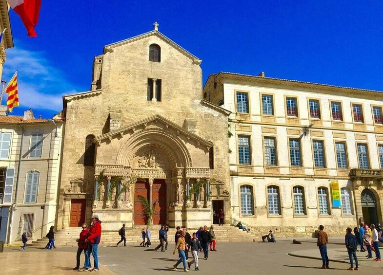 A historic building with a prominent entrance and a large courtyard. 3