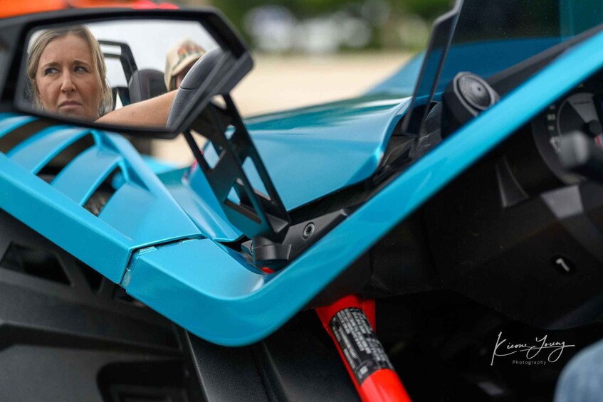 A blue sports car interior with a steering wheel and dashboard. 1