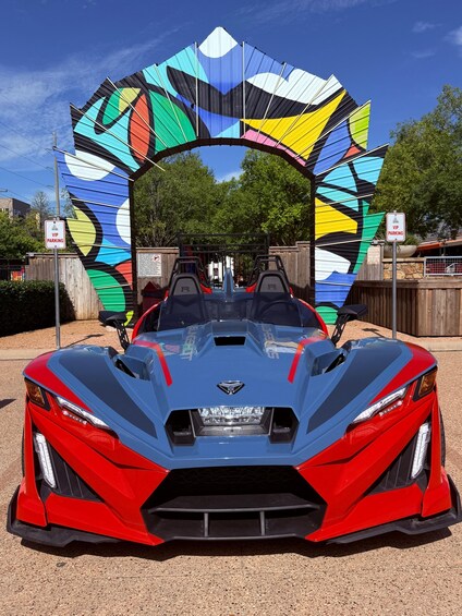 A red sports car with a colorful archway in the background. 3