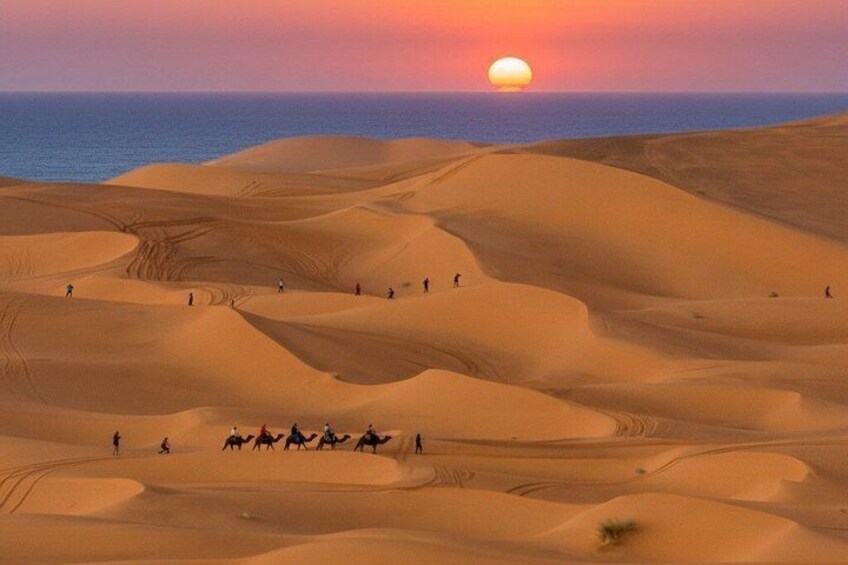 A desert landscape with sand dunes and a sunset. 1