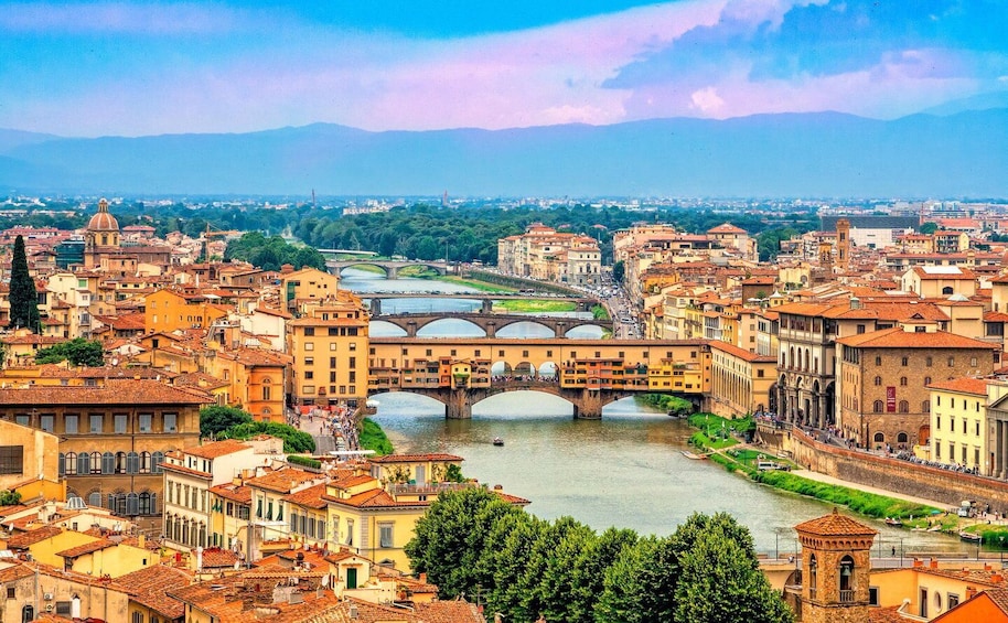 A cityscape with a prominent bridge over a river, surrounded by historic buildings and greenery. 5