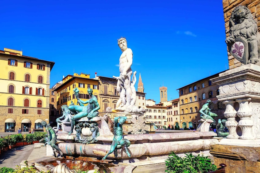 A historic fountain with statues, surrounded by classical architecture. 3