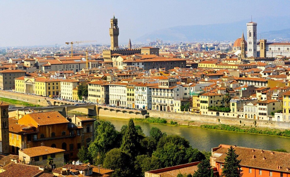 A cityscape with a river, historic buildings, and a prominent tower. 5