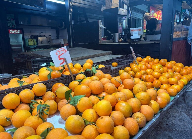 A market stall with oranges on display. 1