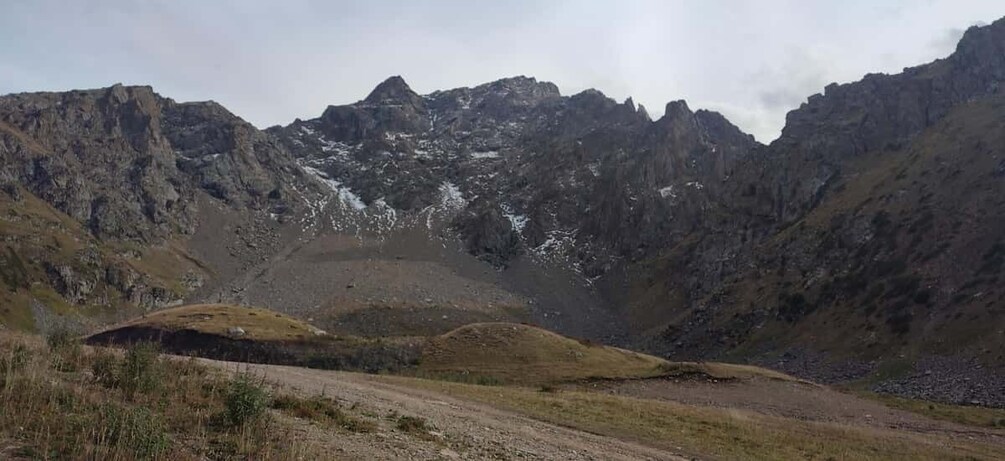 A mountainous landscape with rocky terrain and patches of snow. 4