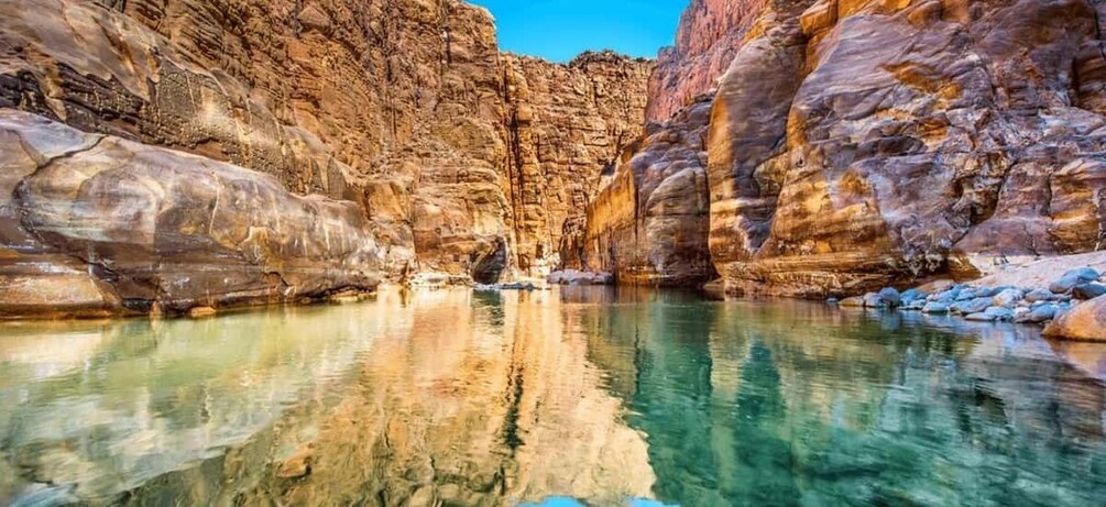 A canyon with clear water reflecting the rock formations. 5