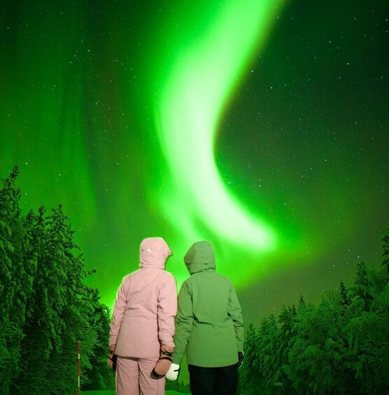 Two people observing the Northern Lights. 1
