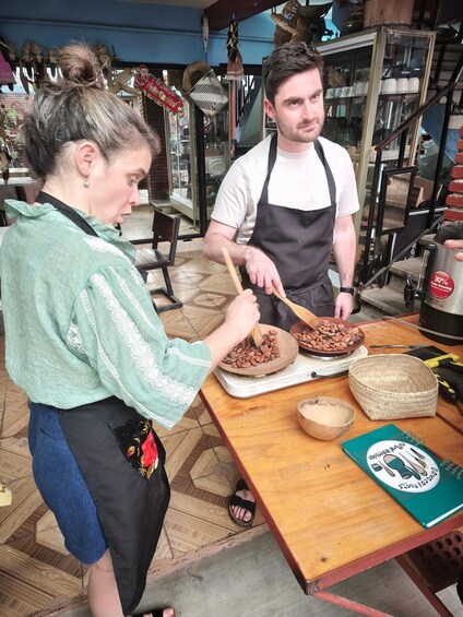 Two people preparing coffee in a kitchen. 4