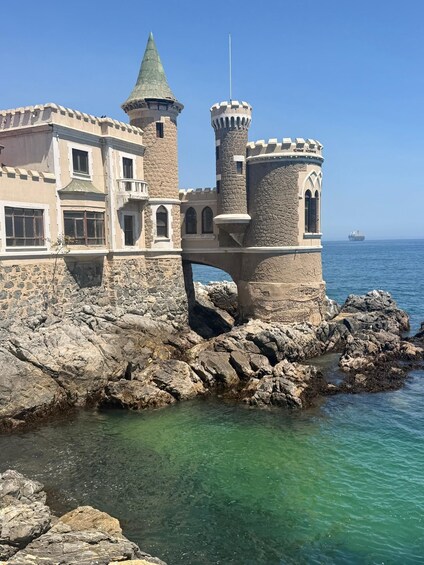 A castle with towers and a bridge over rocky waters. 2