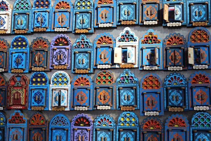A wall of intricately designed blue and orange doors with geometric patterns. 3