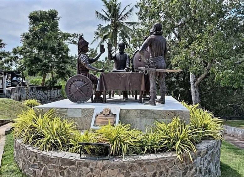 A statue of a man with a sword and a shield, a horse, and another man with a cup. 4