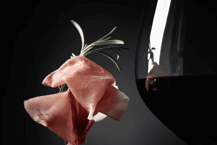 A close-up of a red bell pepper with a sprig of rosemary. 4