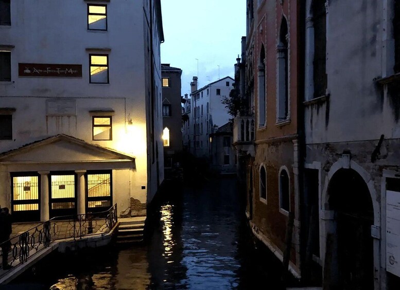 A narrow canal in a historic European town with buildings on either side. 3