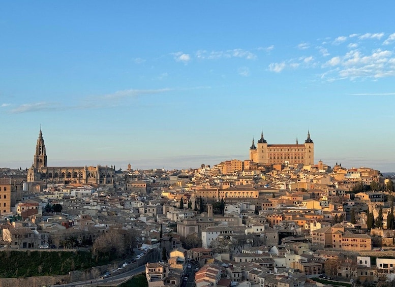 A cityscape with historic architecture, including a prominent cathedral and a large palace. 3