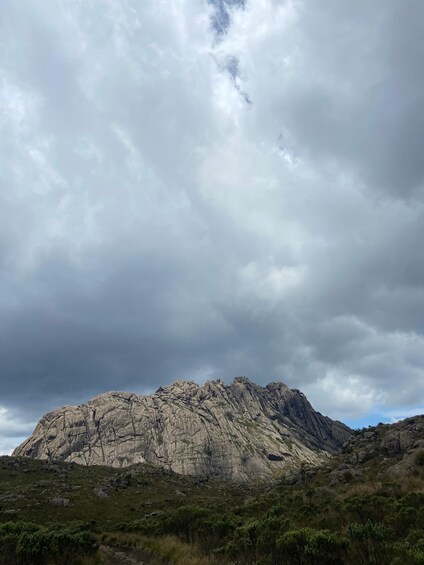 A rugged mountain range under a cloudy sky. 3