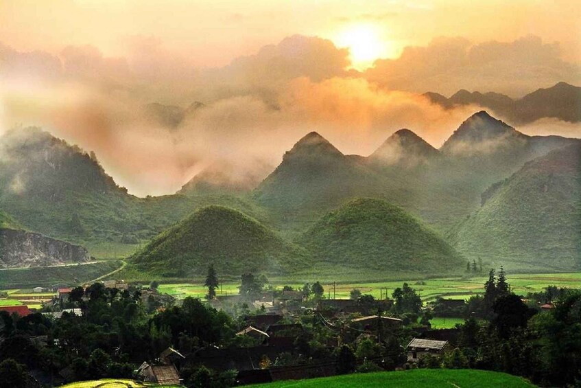 A mountainous landscape with a village nestled in the valley. 5