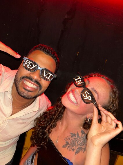 Two people wearing sunglasses with the letters "REY" and "SP" on them. 5