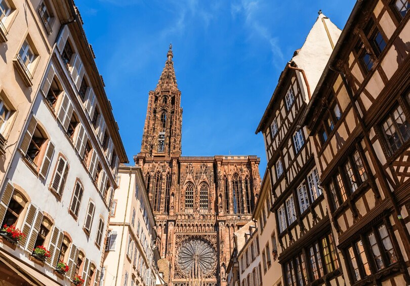 A cathedral with a tall spire and a large circular window. 5