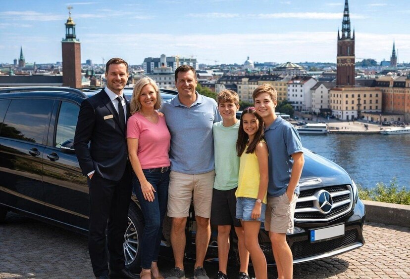 A family posing in front of a car with a cityscape and a river in the background. 1