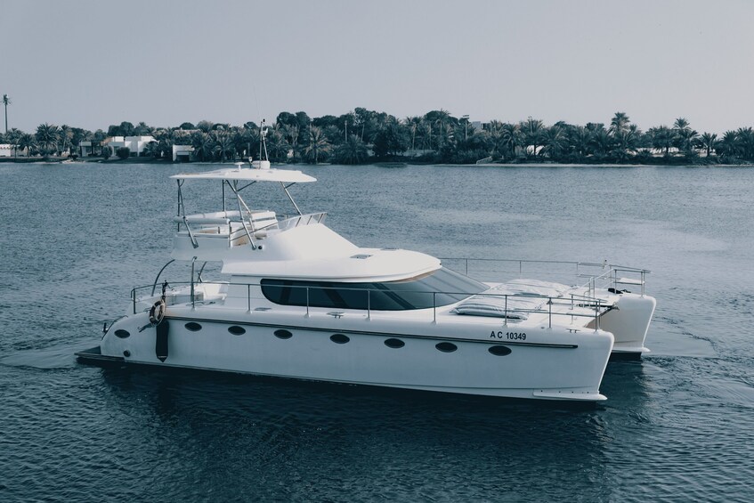 A white yacht with the registration number AC 10349 on calm water. 1
