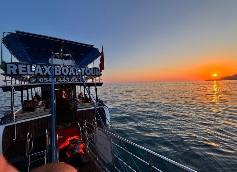 A boat with 'RELAX BOAT TOUR' signage and a sunset in the background. 5