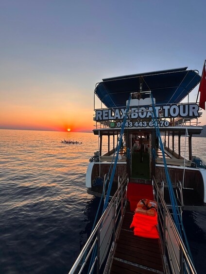 A boat with a sign reading 'RELAX BOAT TOUR' and a contact number. 4