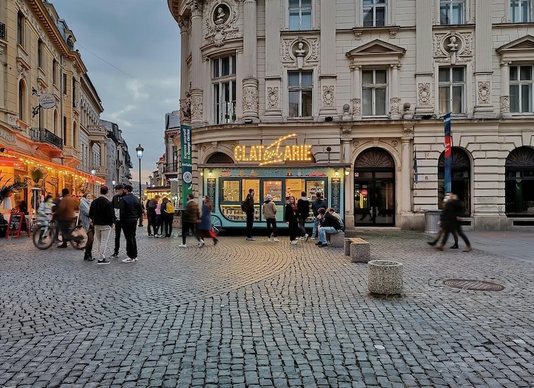 A cobblestone square with a café named 'CLATTERCARTIE'. 3