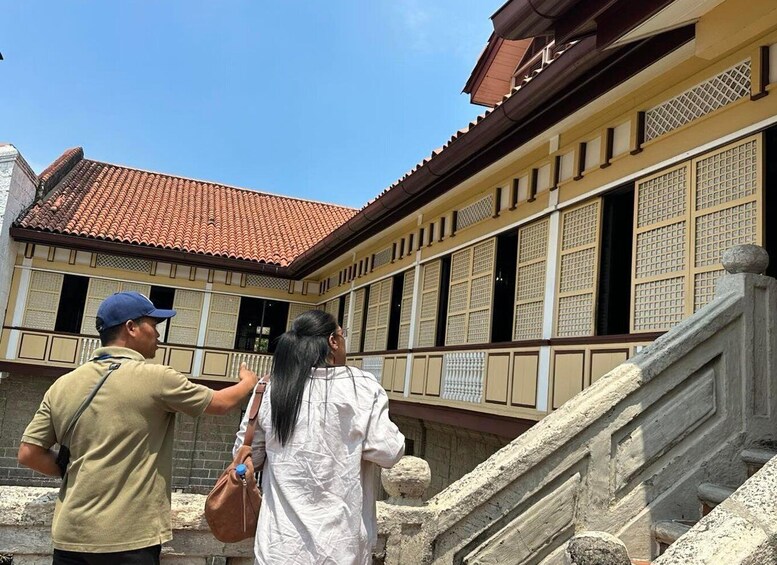 A traditional building with tiled roofs and wooden lattice windows. 3