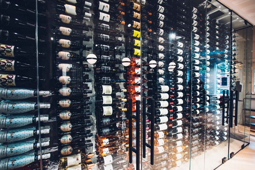 A wine cellar with rows of wine bottles on shelves. 5