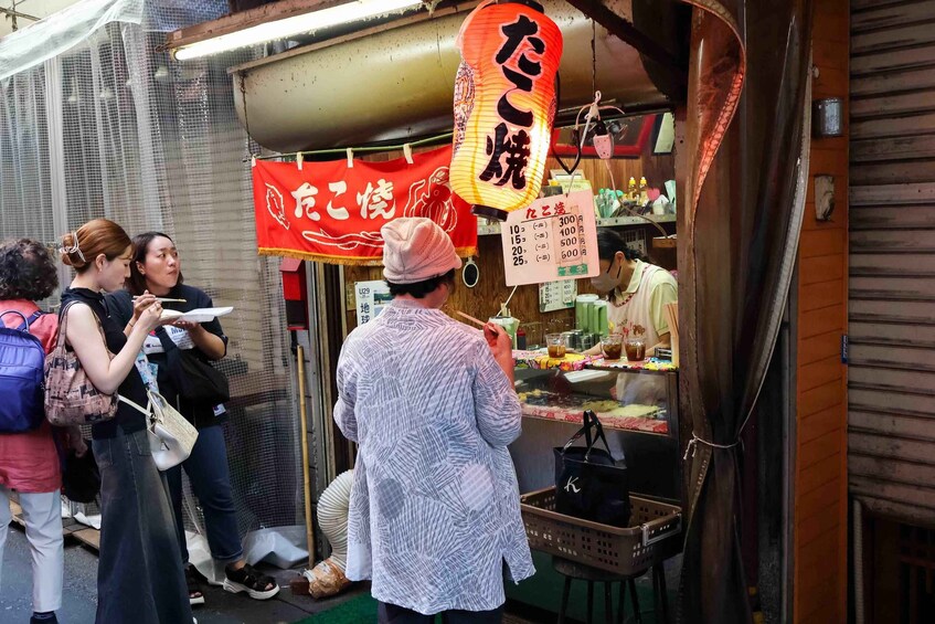 A street food stall with a red sign and a lantern. 5