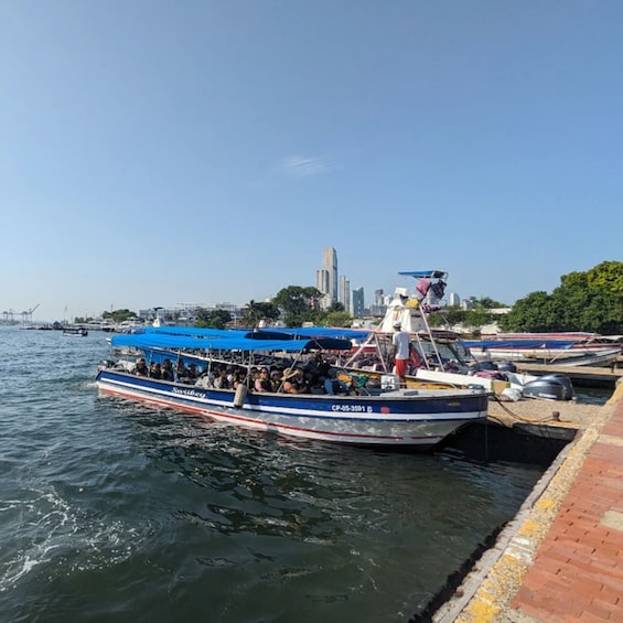 A boat with passengers docked at a pier. 2