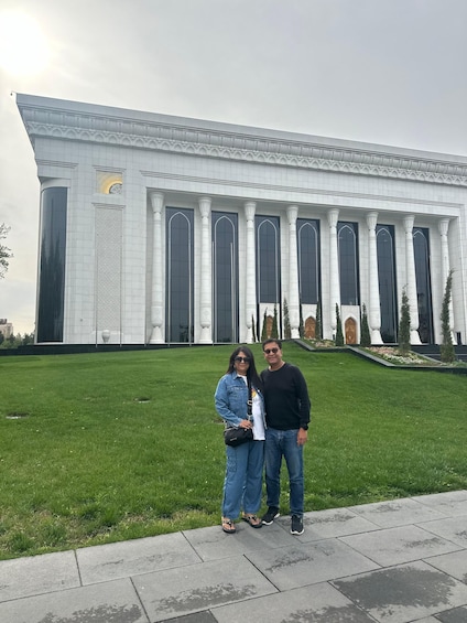 A large white building with columns and a lawn in front. 5