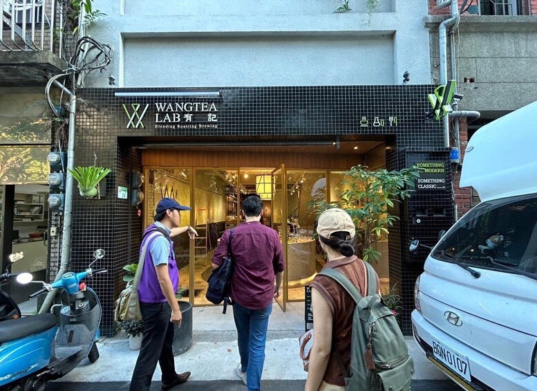 A building with a sign that reads 'WANGTEA LAB Blending Roasting Brewing.' 2