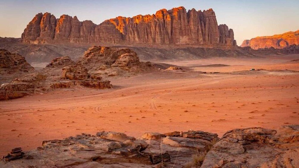 A desert landscape with rocky formations and a clear sky. 2