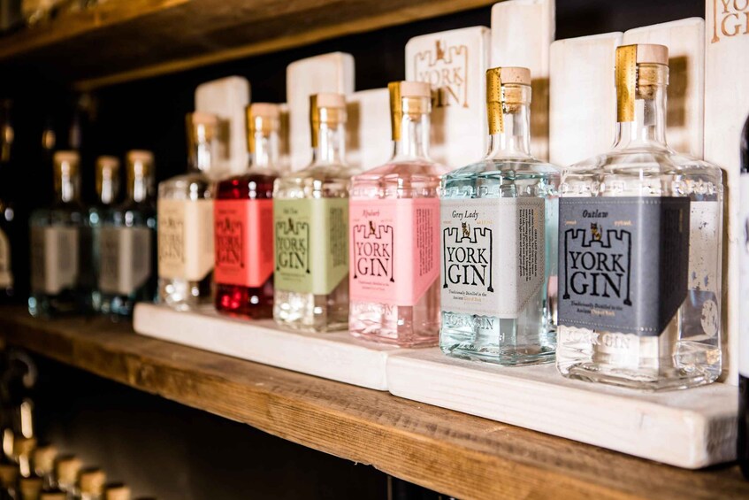 A shelf with various bottles of gin, including brands like 'York Gin' and 'Grey Lady'. 5