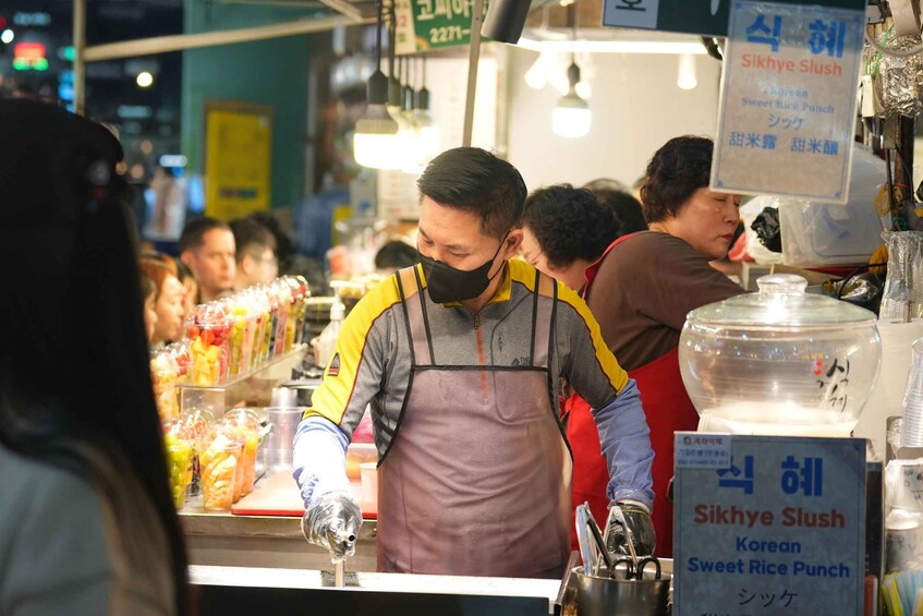 A street food vendor preparing a dish at a food stall. 3