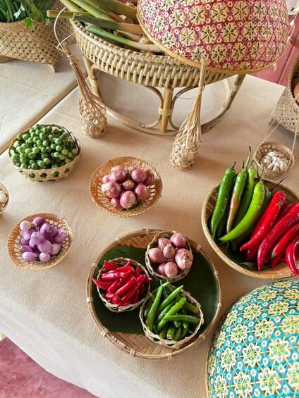 A table with various woven baskets containing different vegetables. 4
