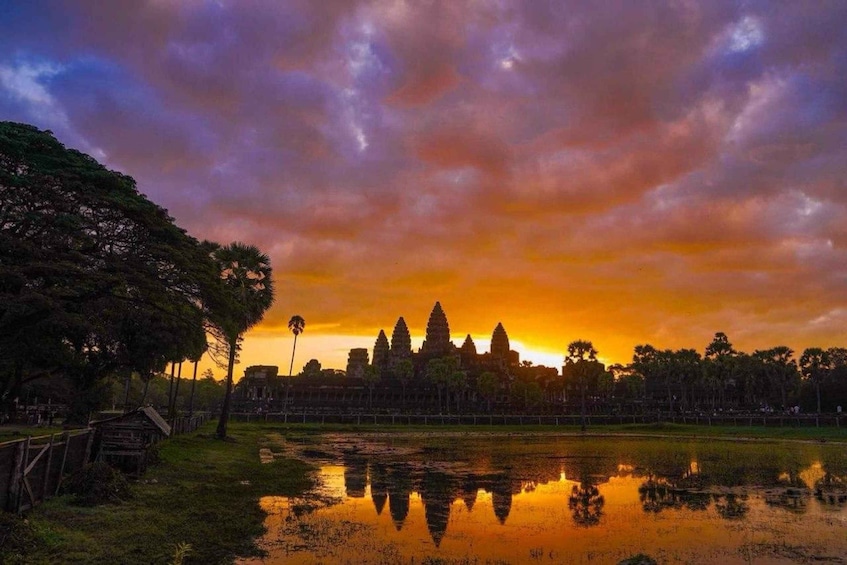 A sunset at Angkor Wat with reflections in the water. 5