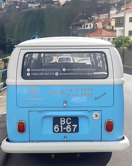 A vintage blue and white van with a license plate 'BC 61-67' and contact information for 'senseandflavourstours' on its rear. 5