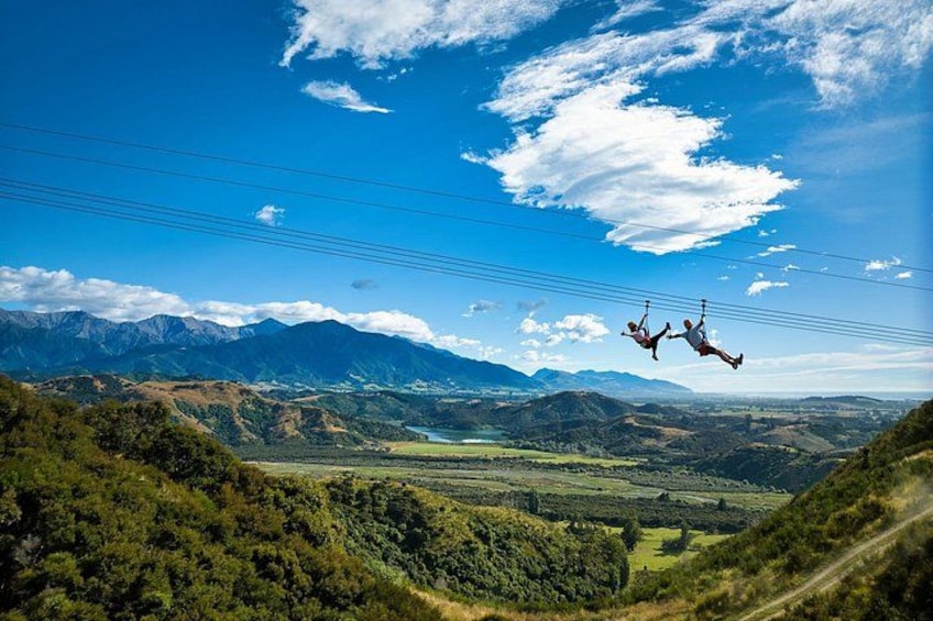 A person skydiving over a mountainous landscape with power lines. 4