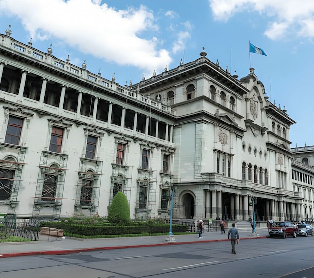 A large, historic building with classical architecture, including columns and arches, under construction with scaffolding. 2